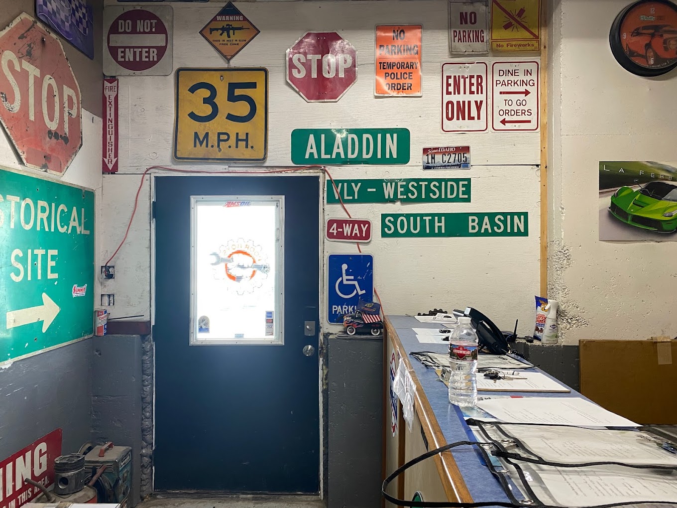 Inside the Poor Boys office — collected road signs and front counter