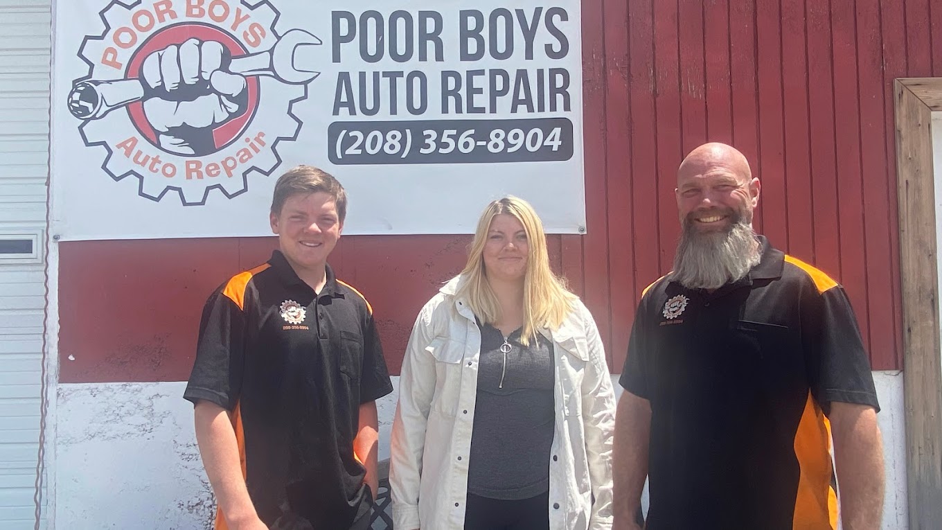 The Poor Boys Auto Repair team standing in front of the shop